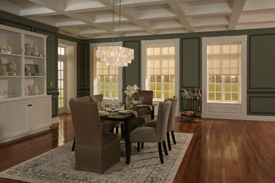  Lutron shades partially lowered over windows in a dining room.