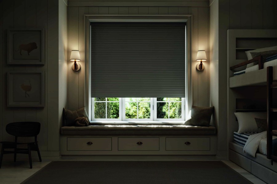 Bedroom showcasing a window seat, bunk beds, and motorized blinds for light adjustment.